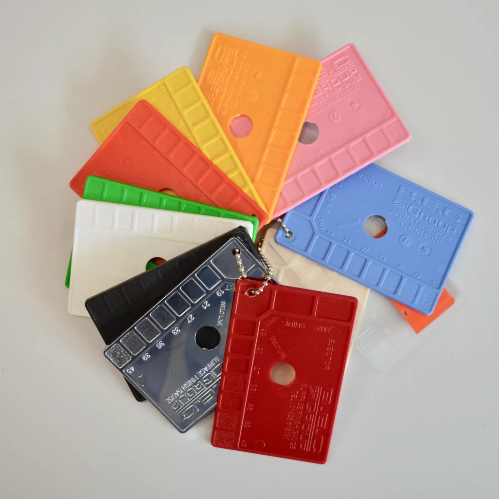 An image of several brightly coloured material sample cards spread out on a table.
